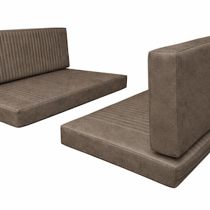 May include: Two-piece brown bench seat with a vertical ribbed design. The seat and backrest are made of a textured material. The backrest is rectangular and angled. The seat is a flat rectangle.