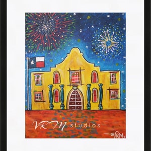 May include: A framed painting of the Alamo mission with fireworks in the night sky. The Alamo is depicted in yellow with red accents, a Texas flag, and the text "VRM studios". The artwork is set against a blue starry background.
