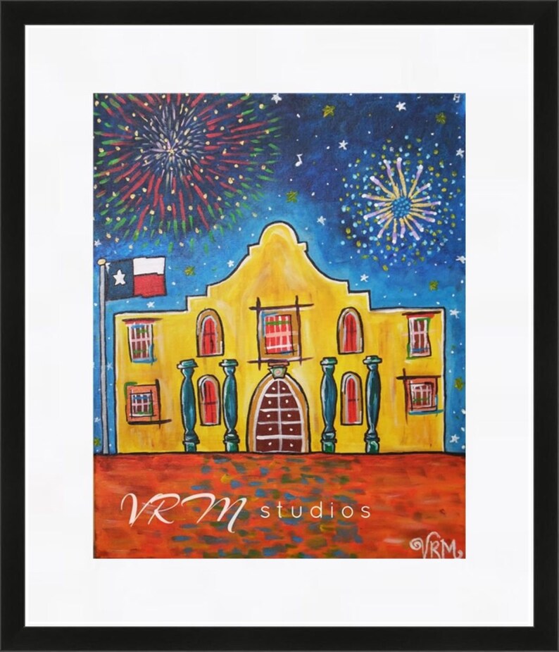 May include: A framed painting of the Alamo mission with fireworks in the night sky. The Alamo is depicted in yellow with red accents, a Texas flag, and the text "VRM studios". The artwork is set against a blue starry background.