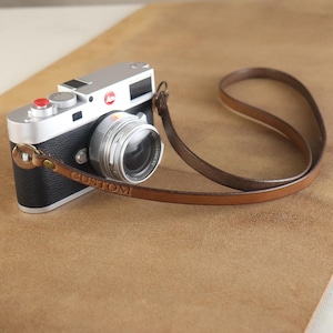 May include: A set of three ceramic mugs with a speckled, matte finish. The mugs are in shades of cream, light gray, and dark gray. Each mug has a simple, modern design and a rounded handle. Perfect for coffee or tea.