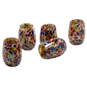May include: Set of five colorful glass tumblers with a speckled pattern. The tumblers are a mix of red, orange, yellow, green, blue, and purple.