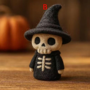 May include: A handmade Halloween decoration featuring a felt skeleton wearing a black witch hat and robe. The skeleton has a skull-shaped face with large black eye sockets and a white rib cage design on the front of the robe.