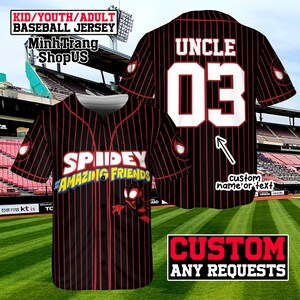 A custom baseball jersey with the name "Uncle" and the number "03" printed on it. The jersey has a spiderman design and the text "SPIDERY AMAZING FRIENDS" printed on it. The jersey is displayed against a backdrop of a baseball field and stadium seating.