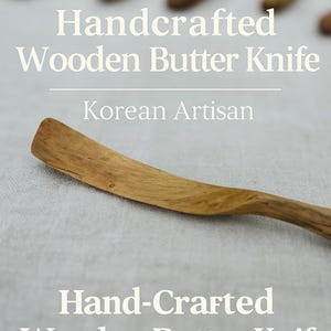 May include: Handcrafted wooden butter knife with a curved blade and handle. The knife is made of light brown wood and is labeled "Handcrafted Wooden Butter Knife" and "Korean Artisan".