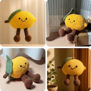 May include: A crocheted lemon toy with a smiling face, green leaf, and brown legs. The yellow fruit is suspended by a string. The toy is a whimsical, soft, and cuddly item, suitable for children or as a decorative piece.