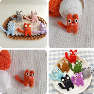 May include: Handmade crochet cat figurines in various colours, including orange, blue, pink, and purple. The cats have large eyes and outstretched arms. Some are arranged on a decorative oval doily.