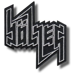 Op de afbeelding: Zwart-wit geborduurde patch met het woord "HÖLSER" in een gedurfde, gestileerde lettertype. De patch heeft een zwarte achtergrond met witte stiksels die de letters en randen omlijnen. Het ontwerp is hoekig en modern.