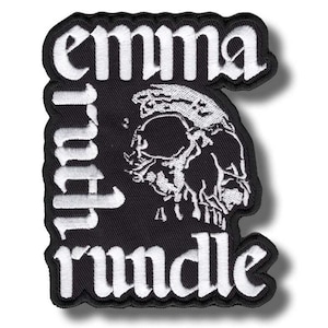 May include: Black embroidered patch with white text and a skull graphic. The patch reads "emma ruth rundle" in a gothic font. The skull is detailed with shading and highlights.