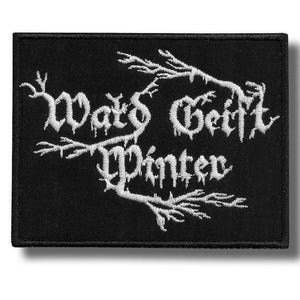 May include: Black rectangular patch with white embroidered text reading "Wald Geist Winter". The gothic font is intertwined with stylized branches.