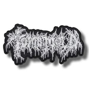 May include: Embroidered patch with the word "SOMNIUM" in a stylized, gothic font. The white text has a dripping effect, set against a black background with a black border. The patch is likely for clothing or accessories.