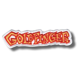 以下が含まれることがあります： 黄色と赤色の糸で「GOLDFINGER」という文字が刺繍されたパッチ。パッチには白い縁取りと影があり、3D効果を生み出しています。長方形のパッチは、布にアイロンをかけたり縫い付けたりするように設計されています。