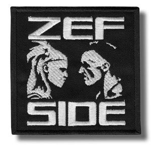 May include: Black square patch with white embroidered text and imagery. The word "ZEF" is at the top, and "SIDE" is at the bottom. Two profile portraits face each other in the centre.
