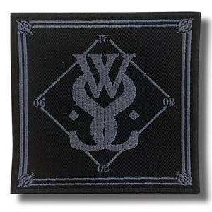 May include: A black square patch with a gray border and a gray emblem. The emblem features intertwined letters and numbers 06, 08, 20, and 21. The patch has a decorative border.