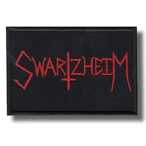 Può includere: Toppa rettangolare nera con la scritta "SWARZHEIM" ricamata in rosso, con un simbolo a croce. La toppa è progettata per essere applicata su abbigliamento o accessori.