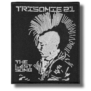 May include: Black embroidered patch with a punk rock design. The patch shows a profile of a person with a mohawk and the text "TRISOMIE 21" and "THE LAST SONG" in white.