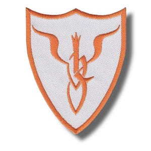 May include: Shield-shaped embroidered patch with a white background and an orange border. The patch has an orange, stylized design in the centre. The patch is designed to be ironed or sewn onto fabric.