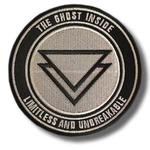 May include: Circular patch with the text "THE GHOST INSIDE" at the top and "LIMITLESS AND UNBREAKABLE" at the bottom. The patch features a black border, a light gray center, and a black double-arrow design.