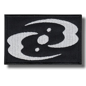 May include: Black rectangular patch with a white abstract design. The design features a stylized, curved shape with three white dots. The patch has a woven texture and a black border.