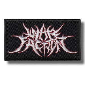 May include: Black rectangular patch with white and red embroidered text. The text is stylized and appears to be a band logo or emblem. The patch has a black border and is likely made of fabric.