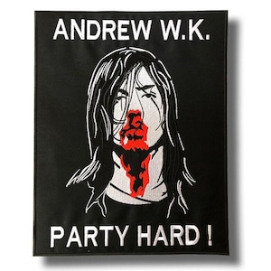 May include: Black rectangular patch with white embroidered text "ANDREW W.K." at the top and "PARTY HARD!" at the bottom. The patch features a stylized illustration of a person with long black hair and red blood-like imagery.