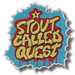 May include: Embroidered patch with the text "STOUT CALLED QUEST" in yellow, outlined in black, on a red and blue background. The patch has a star at the top and a jagged edge.