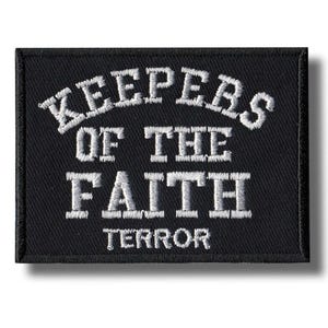 May include: Black rectangular patch with white embroidered text. The text reads "KEEPERS OF THE FAITH" above "TERROR". The patch has a black border and is likely designed to be sewn or ironed onto clothing or accessories.