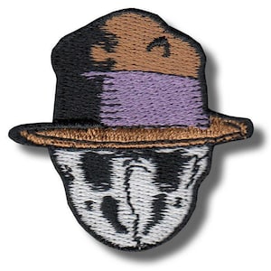 May include: Embroidered patch depicting a stylized face wearing a hat. The hat is black, brown, and purple. The face is white with black details, resembling a mask. Suitable for clothing or accessories.
