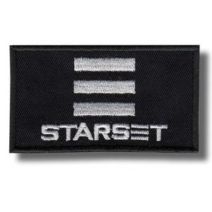 May include: Black rectangular patch featuring the word "STARSET" embroidered in white, beneath three horizontal white lines. The patch has a black border, possibly a logo or emblem.