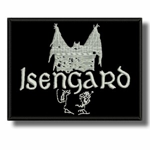 May include: Black embroidered patch with the word "Isengard" in white, featuring a castle design above the text and two small figures below. The patch has a black border and a shadow effect.