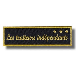 May include: A rectangular black embroidered patch with gold edging. The text "Les traiteurs indépendants" is embroidered in gold, with three gold stars. The patch is likely for a catering business.