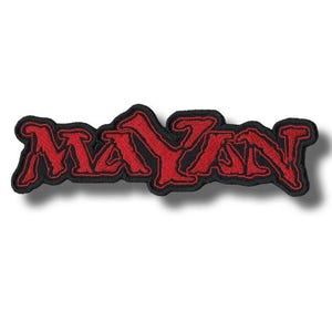 May include: Embroidered patch with the word "MAYAN" in bold, red letters. The letters have a stylized, gothic font and are outlined in black. The patch is rectangular and has a black border.