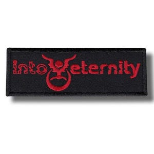 May include: A black rectangular patch featuring the embroidered words "Into Eternity" in red. The design includes a stylized symbol above the word "eternity". This patch is likely for clothing or accessories.