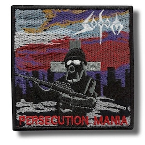 May include: Embroidered patch featuring a soldier in a gas mask holding a rifle, set against a backdrop of a cross and a cityscape. The patch has the word "SODOM" in white and "PERSECUTION MANIA" in red.