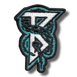 May include: Embroidered patch with a stylized design in white, teal, and black. The patch features a geometric shape with intricate details and a black border. The design includes the letters "T" and "R" in a unique font.