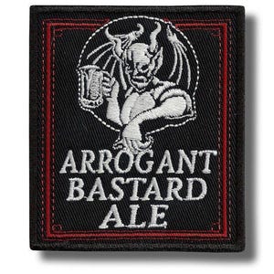 May include: Black embroidered patch with a red border. It features a white illustration of a devil holding a beer mug. The text "ARROGANT BASTARD ALE" is displayed in white, stylized lettering.