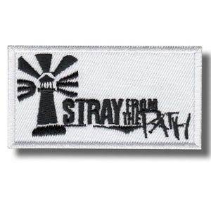 Op de afbeelding: Een rechthoekige patch met een witte achtergrond en een zwart geborduurd ontwerp. Het ontwerp toont een vuurtoren met stralen en de woorden "STRAY FROM THE PATH" in zwarte letters.