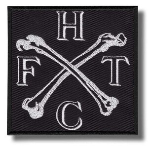 May include: Black square patch with white embroidered design. Features crossed bones and the letters H, F, T, and C. The patch has a black border and a shadow.