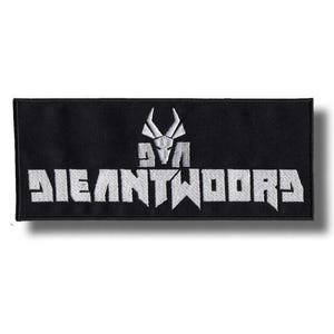 May include: Black rectangular patch featuring white embroidered text and a stylized emblem. The text reads "DIEANTWOORD" in bold, block letters. Above the text is a white emblem of a horned skull.