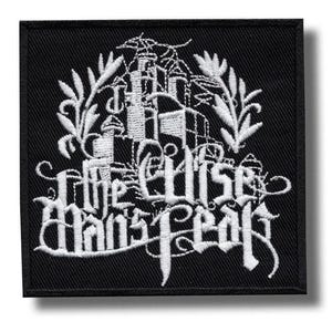 May include: Black square patch with white embroidered text and imagery. The text reads "The Elise Mans Fear" in a gothic font, with a castle and floral design above. The patch has a black border.