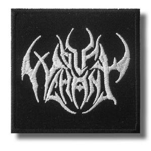 May include: Square black patch with white embroidered gothic lettering. The patch features a stylized design with sharp, angular lines and a bold, eye-catching aesthetic. The patch is likely for clothing or accessories.