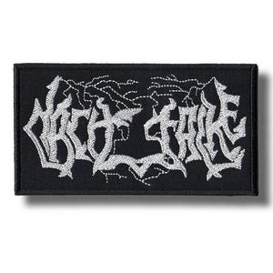 May include: Black rectangular patch with white embroidered text. The text is stylized in a gothic font. The patch has a white border and is likely for clothing or accessories.
