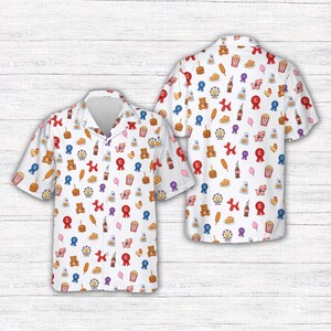 May include: White button-down shirt with a colorful carnival-themed pattern. The design includes teddy bears, ribbons, popcorn, corn dogs, and other fairground icons. The shirt has short sleeves and a classic collar.