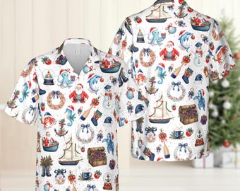 May include: White short-sleeved shirt featuring a festive nautical Christmas pattern. The design includes Santa Claus, snowmen, sailboats, anchors, and wreaths. The shirt has a relaxed fit.