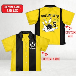 May include: Yellow and black bowling shirt with a bowling pin graphic and the text "Rollin' Into 5". The shirt has a button-down front and a collar. The front of the shirt has a bowling pin graphic and the word "Name".