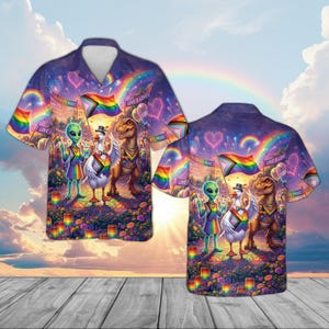 May include: A short-sleeved button-down shirt with a vibrant Pride-themed design. The shirt features a colorful illustration of an alien, a goose, and a dinosaur holding Pride flags, set against a rainbow and fireworks background.