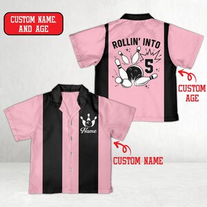 May include: Pink and black bowling shirt with the text "ROLLIN' INTO 5" and a bowling pin graphic on the back. The front of the shirt has a bowling pin graphic and the word "Name". The shirt has a button-down front.