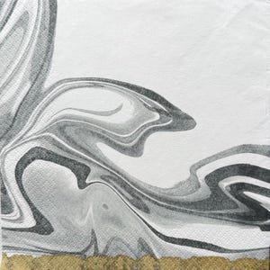 May include: A square white paper napkin with a marbled design in shades of gray and black. The swirling pattern resembles flowing water or smoke. The bottom edge has a gold border.