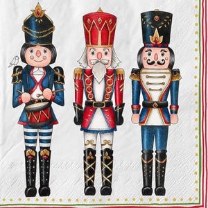 May include: Three colorful nutcracker figures are depicted on a white background with a red and green border. The nutcrackers wear ornate uniforms in red and blue, with tall hats and detailed facial features. One holds drumsticks, another has a long white beard.