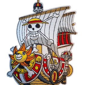 May include: An embroidered patch featuring a ship with a yellow sun-shaped figurehead, a white sail displaying a skull and crossbones wearing a straw hat, and a red and gold hull with the number one printed on the side in a circular frame.