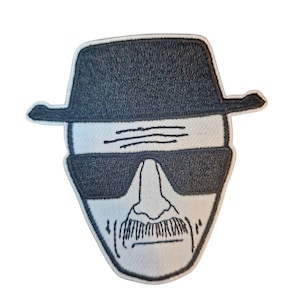 May include: Embroidered patch featuring a stylized face with a fedora, sunglasses, and a mustache. The patch has a white background with black embroidered details. The design is a recognizable pop culture reference.
